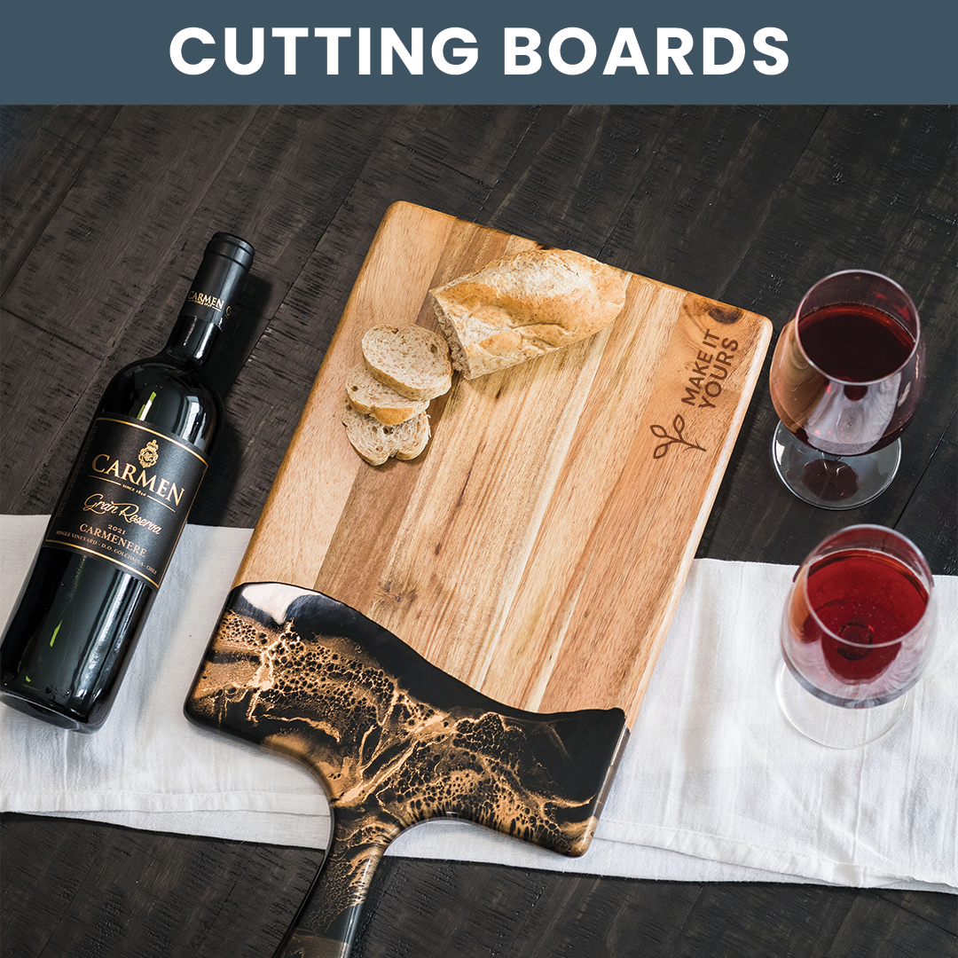 Lifestyle image of a cutting board on kitchen table surrounded by wine glasses and bottle of wine