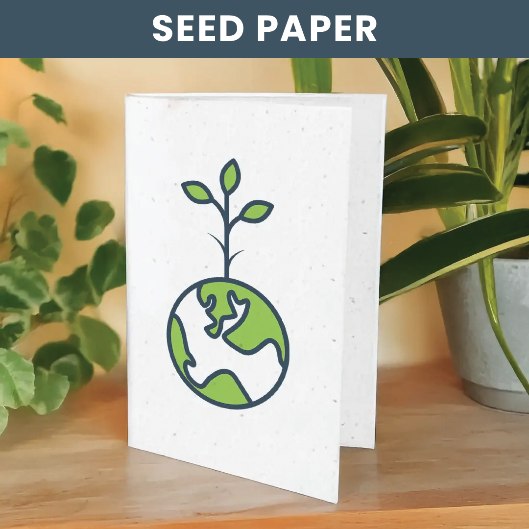 Lifestyle image of seed paper card placed on wooden table surrounded by plants