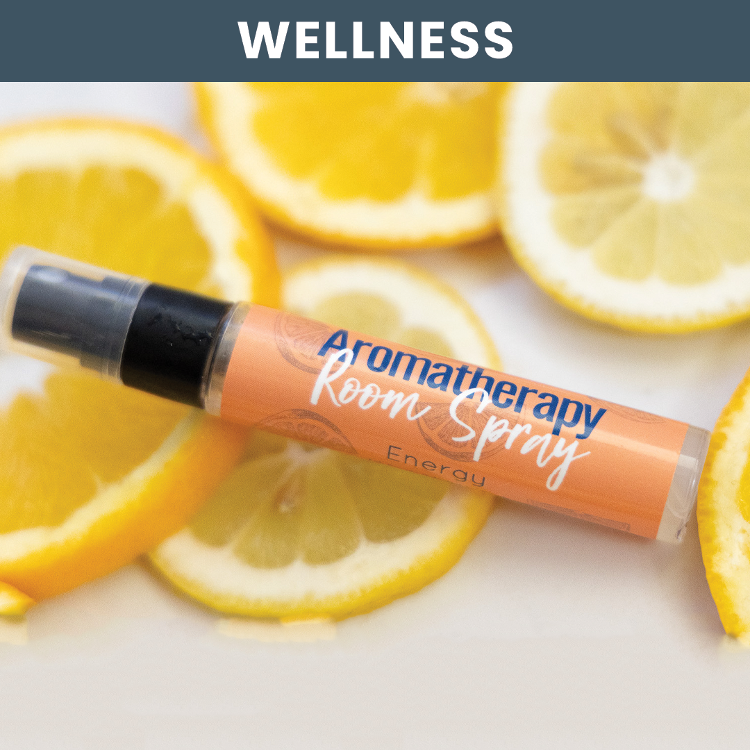 Lifestyle Image of aroma spray laying on a surface of fresh orange slices