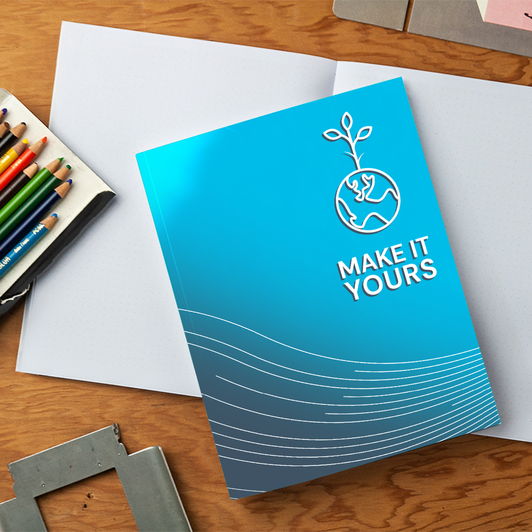 Lifestyle image of notebook on messy desk with pencils and paper Lifestyle image of notebook on messy desk with pencils and paper